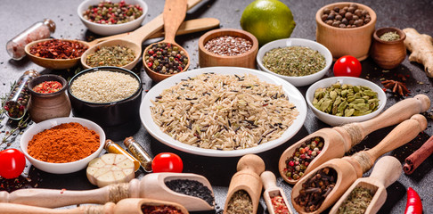 Spices and herbs over black stone background. Top view with free space for menu or recipes