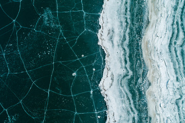 Ice On Reservoir Shore With Cracks, Top View