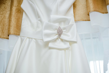 Obraz na płótnie Canvas Bow on a white dress of the bride. Accessories and details