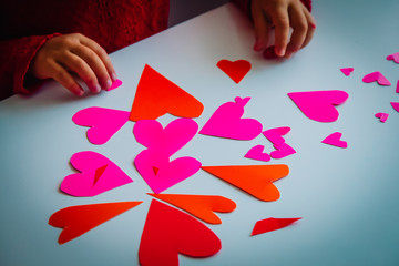 child making hearts from paper, prepare for valentine day