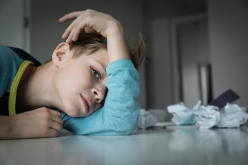 Child tired and bored of doing homework, kid stressed from learning