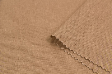 Fabric suit fold top view. Beige color textile