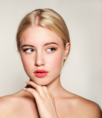 Portrait of beautiful blonde young woman face.  Spa model girl with fresh clean skin isolated on a...