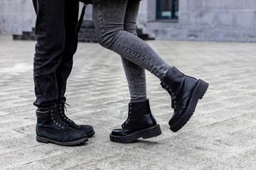 Legs of a young couple in love kissing on the street.