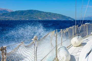 Side of a White Yacht and Water Spray