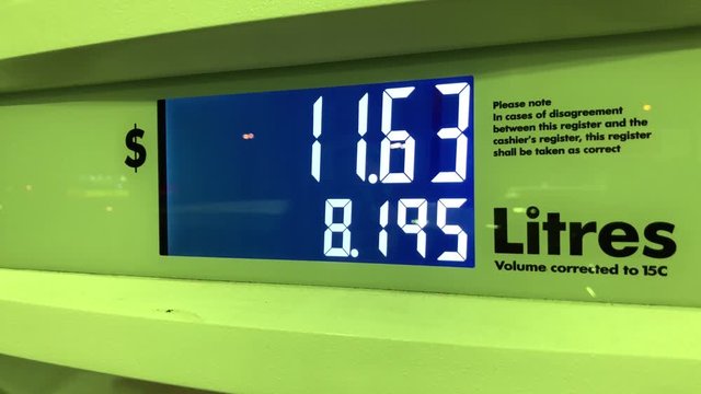 Motion of big screen of rising gas prices on pump scree at night with 4k resolution