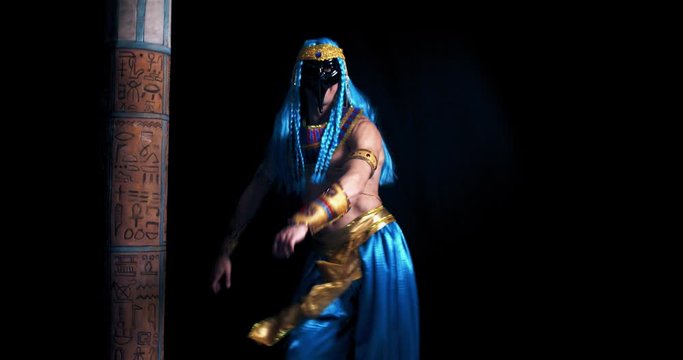 A man dressed as an ancient egyptian god is flossing, 4k