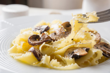Spaghetti reginelle pasta with mushrooms. Tasty dinner. Close up.