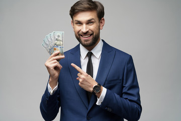 young handsome businessman holding US dollar bills