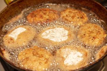Meat patties fried in a pan
