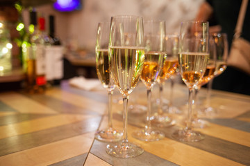 a row of crystal glasses with wine and champagne.