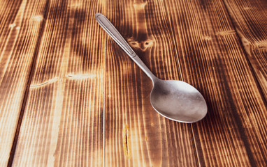 Spoon for food on a wooden background