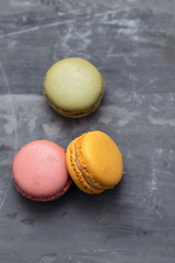 delicious colorful macaroons on ceramic background