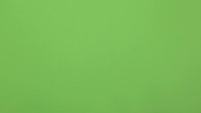 Man hand snap finger or clicks hand isolated on chroma key green screen. Calling a taxi or a waiter