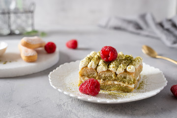 Matcha Tiramisu Dessert with raspberries and Green tea on concrete background. Superfoods, healthy nutrition. Menu, confectionery concept. Close up