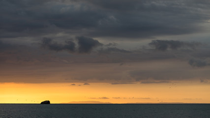 Fototapeta premium Sunset on the beaches of the Pacific Ocean in Costa Rica with a stormy sky and beautiful clouds.