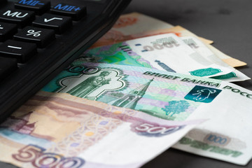 Close up photo of stack of Russian money rubles with calculator