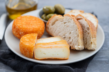 appetizer cheese with bread and olives on dish