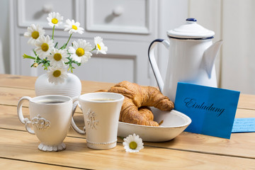 Table With Croissants And Envelope With German Word For Invitation