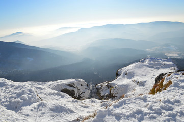 Winter Carpathian mountains on a bright sunny day. Winter snow covered mountain peaks