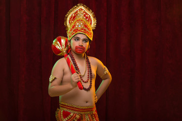 lord hanuman standing on stage