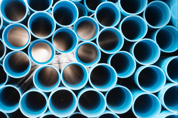 Blue plastic pipes used in construction site.Blue PVC water pipe in storage.Packaged blue plastic...