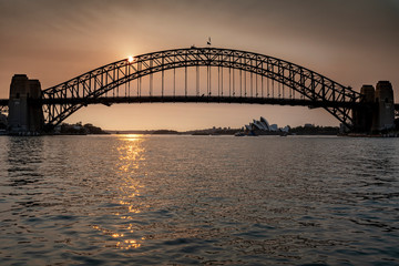 Fototapeta na wymiar Sydney Harbour Bridge seen across the water at sunset