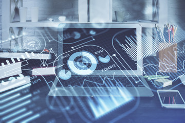 Computer on desktop in office with technology theme hologram. Multi exposure. Tech concept.