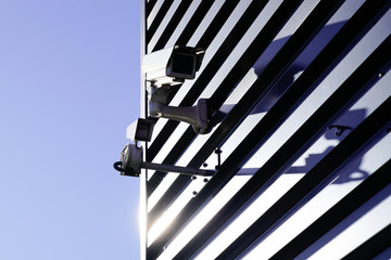 View of security camera on wall modern building sunrise