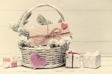 Valentine’s day concept with decorative envelope and gift boxes. Warm color toned image. Old photo stylized