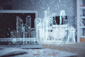 Desktop computer background in office and big town buildings hologram drawing. Double exposure. Smart city concept.