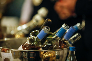 Details with wine bottles inside an ice bucket in a bar