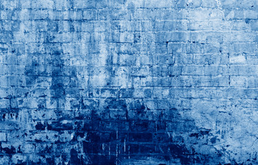Aged stone wall, abstract background toned in trendy Classic Blue color of the Year 2020
