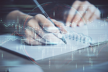 Forex graph on hand taking notes background. Concept of research. Double exposure