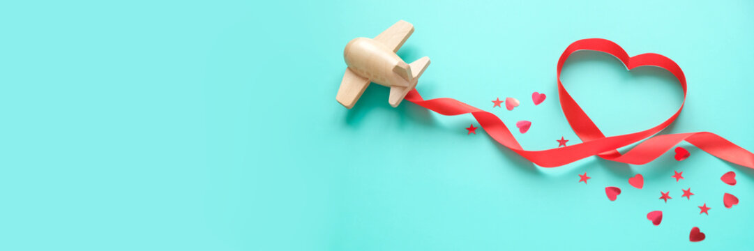 Small Wooden Toy Airplane Lucky With Red Ribbon In The Shape Of Heart