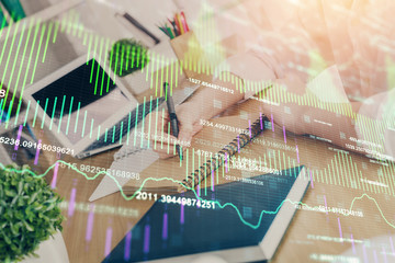 Financial graph displayed on woman's hand taking notes background. Concept of research. Double...