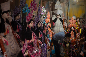 Clay idols of Hindu Goddess Saraswati being made and displayed for the Indian Bengali festival in winter in Bengal. Indian culture and religion.