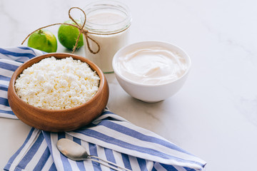 Healthy breakfast of cottage cheese with sour cream and lime on a marble table