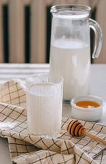 Healthy breakfast of cottage cheese with sour cream and honey on a marble table