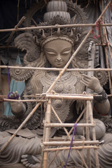 Clay idols of Hindu Goddess Saraswati being made and displayed for the Indian Bengali festival in winter in Bengal. Indian culture and religion.