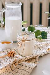 Healthy breakfast of cottage cheese with sour cream, honey and lime on a marble table