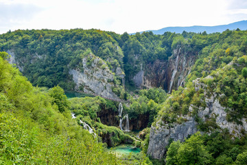 Plitvice Lakes National Park, Croatia - a UNESCO World Heritage Site. Interconnected turquoise lakes. Around the lakes are trees and rocks, which are washed by the water of the lakes.