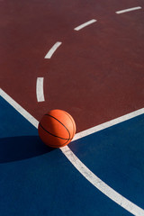 An orange ball on basketball court