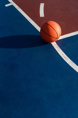 An orange ball on basketball court