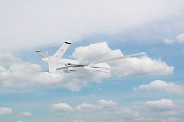 Fototapeta na wymiar military RC military drone flies against the backdrop of blue peaceful sky with white clouds