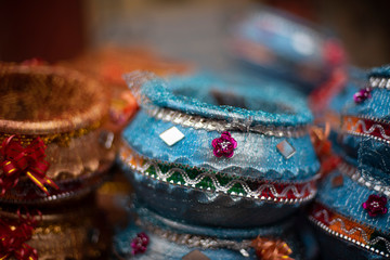 Blue decorative earthen pots are displayed in a local street shop for sale. Indian market and handicraft.