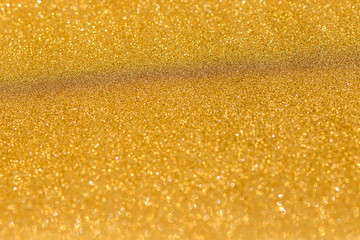 Gold background light. Golden glitter texture.