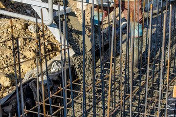 steel rebar for reinforcement concrete at construction site with house under construction background,Industrial background.Rusty rebar for concrete pouring.