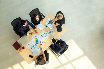 young business team working together at office. Manager pointing at a chart and explaining the...