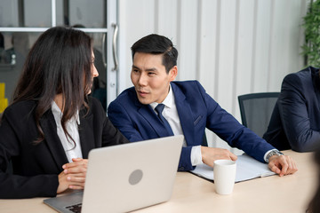 Fototapeta premium Young manager man flirting with businesswoman on table in meeting room